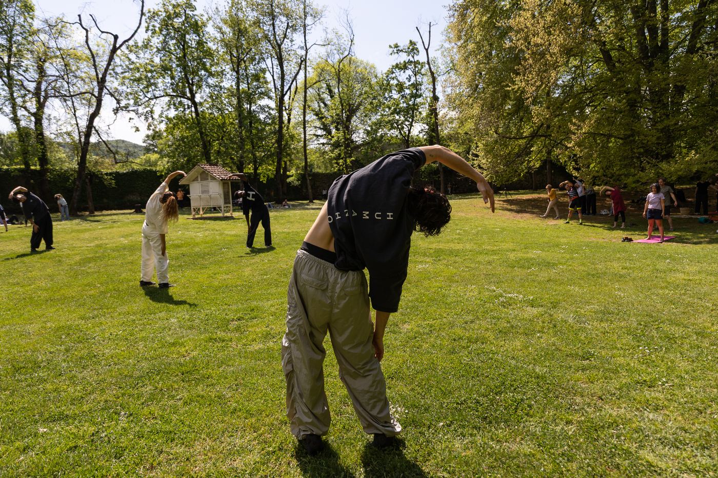 A group practising the opening SYNC movements outdoors
